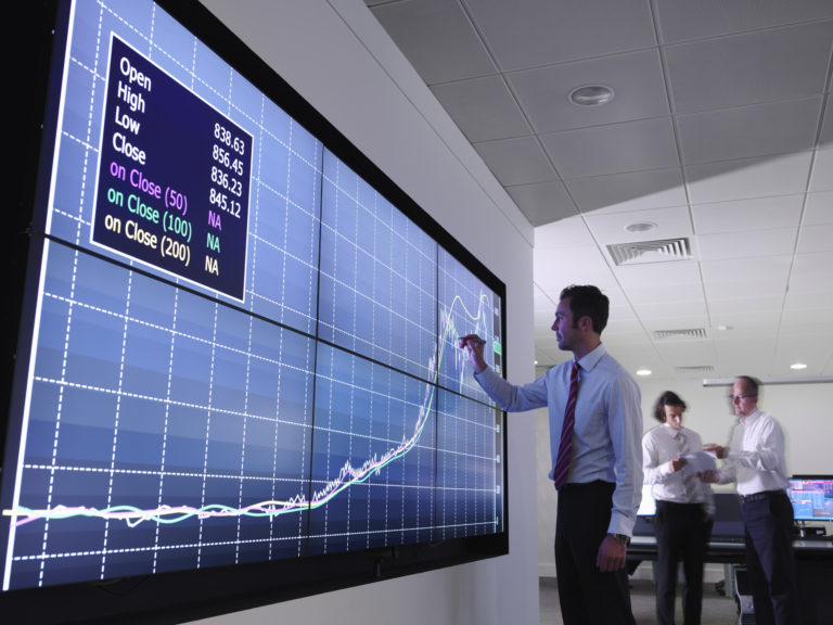 Businessman using graphs on screen --- Image by © Monty Rakusen/cultura/Corbis